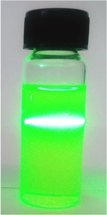 Dispersoil nanofluid vial scattering a bright green laser beam
